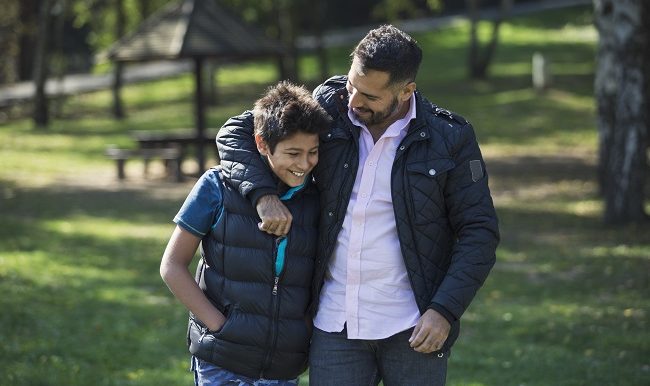 Father and son in public park